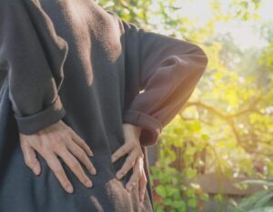 woman holding back in pain