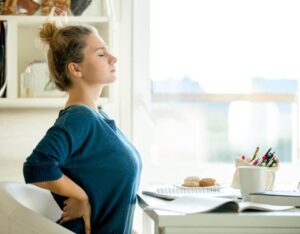 woman holding her back