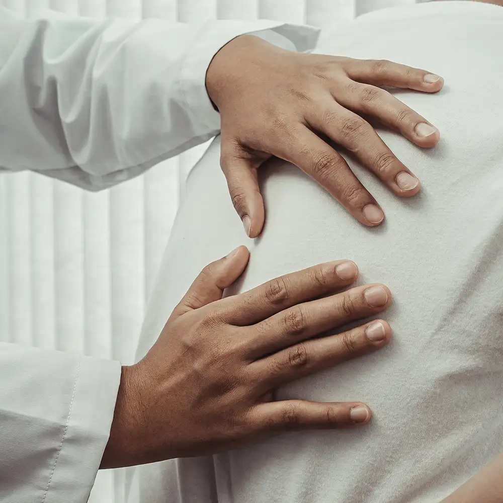 A Spine Surgeon Examines a Patient’s Back at Spine Solutions in Miami, FL